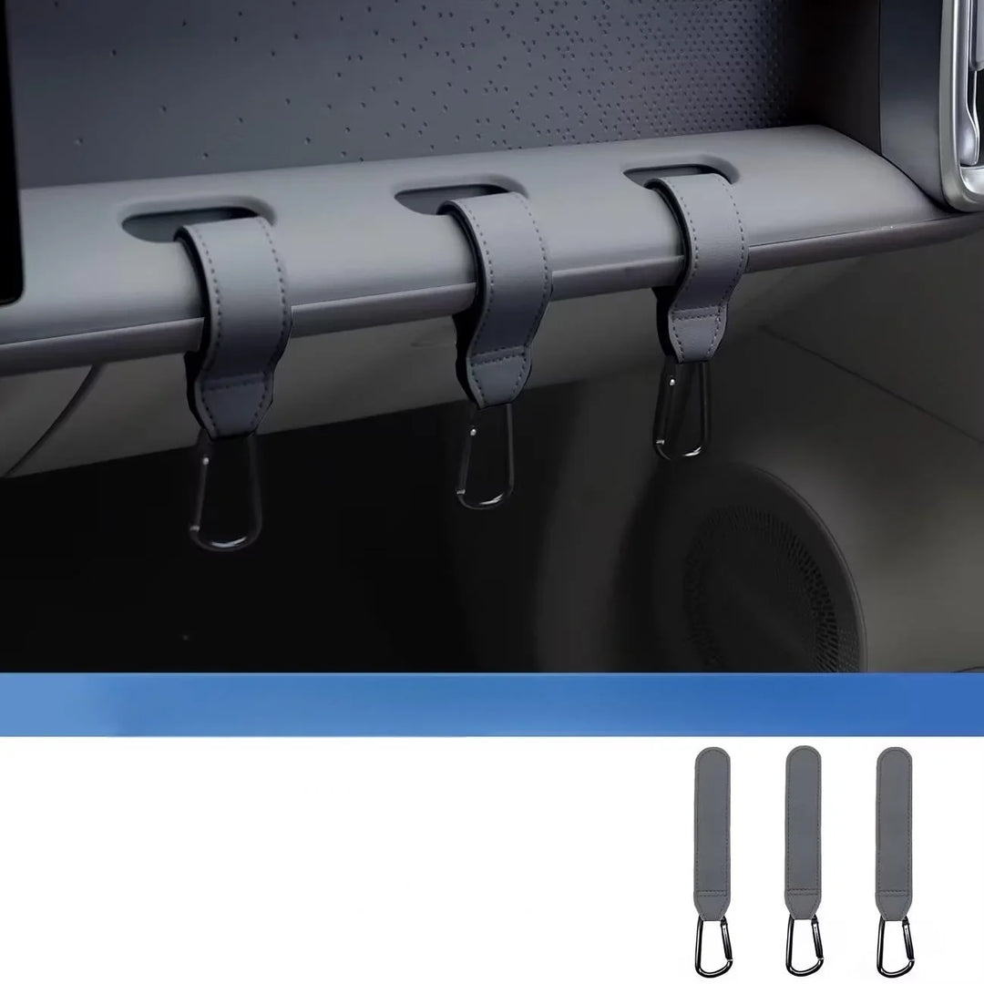 Three grey car interior storage hooks installed in a vehicle dashboard and shown separately.