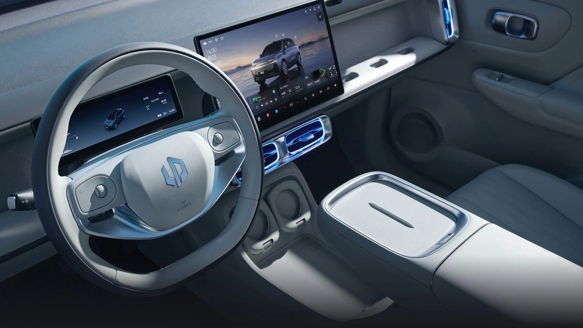 Interior view of a Leapmotor electric vehicle cockpit featuring a large digital display and steering wheel