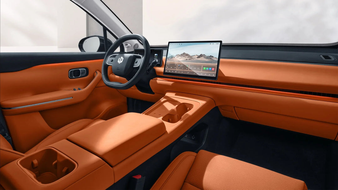 Interior of a Leapmotor car featuring orange leather upholstery and a digital dashboard screen.